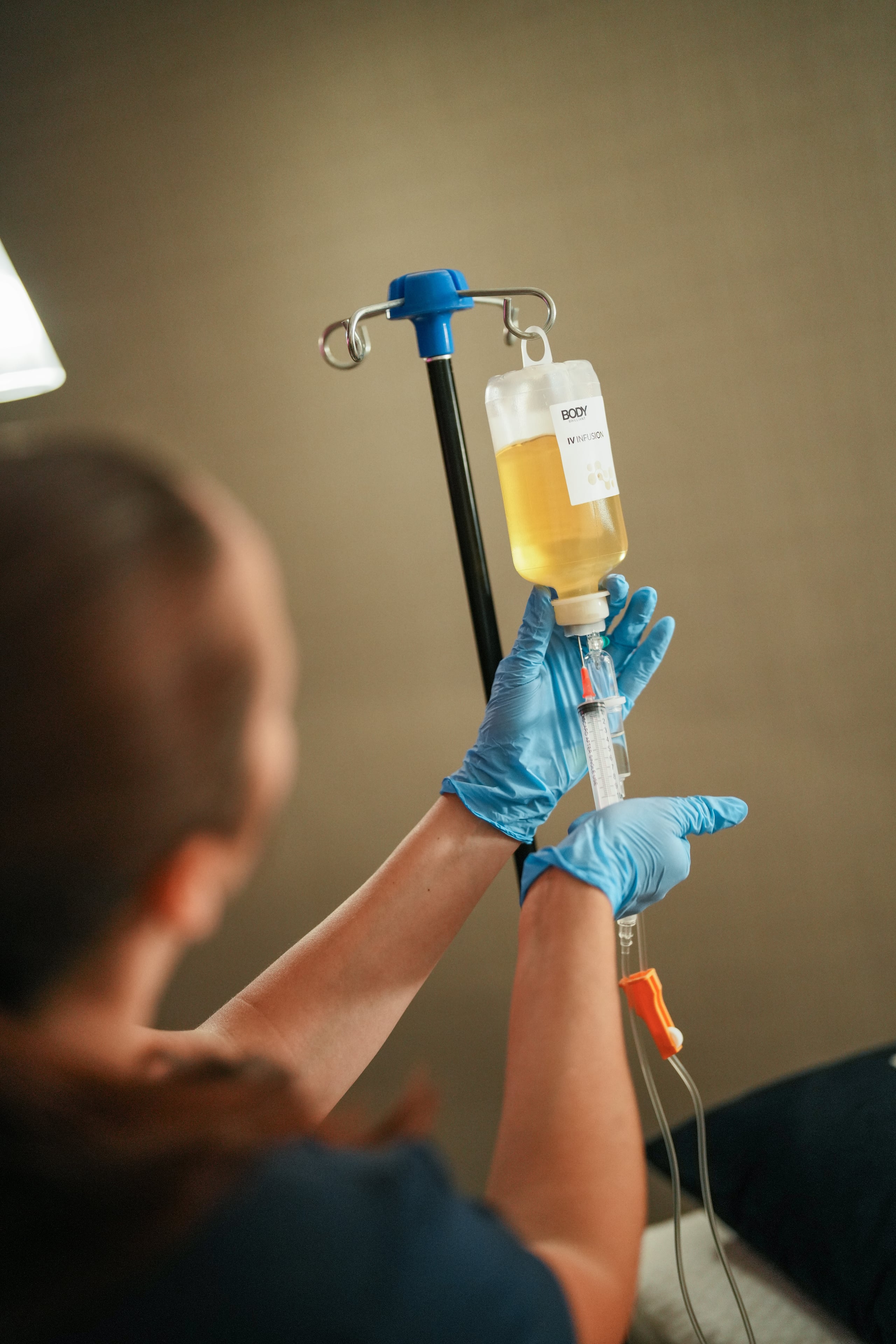 A Body Brilliant IV bag prepared by hand — pharmaceutical-grade infusion therapy